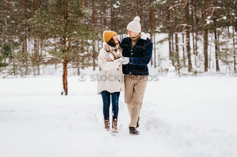 Similar – Teenage girl pulling sled with her little sister through forest