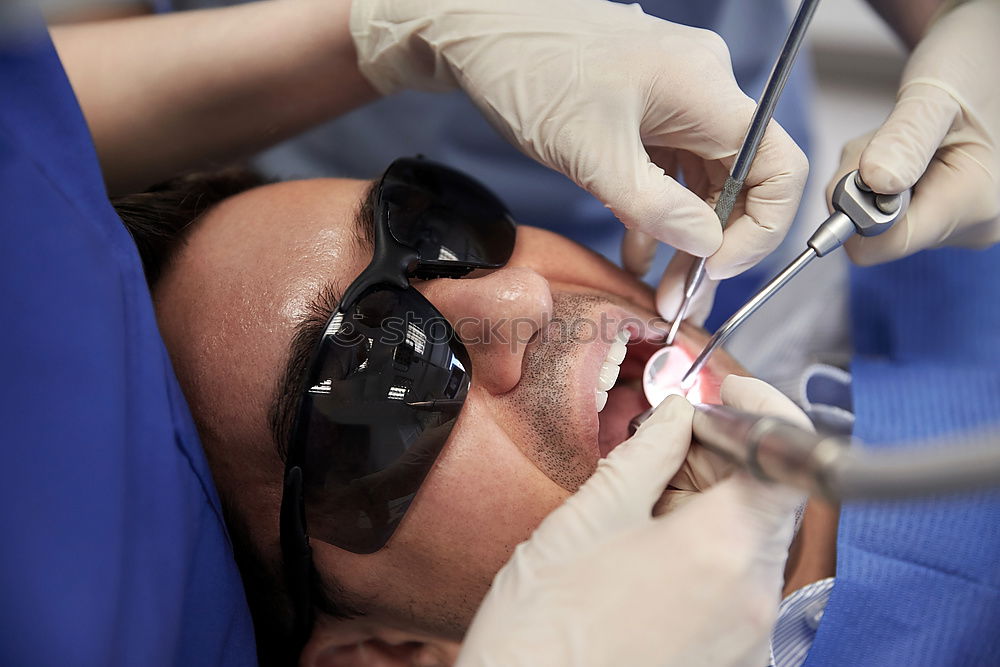 Similar – Seated young man is being examined his teeth by a dentist.