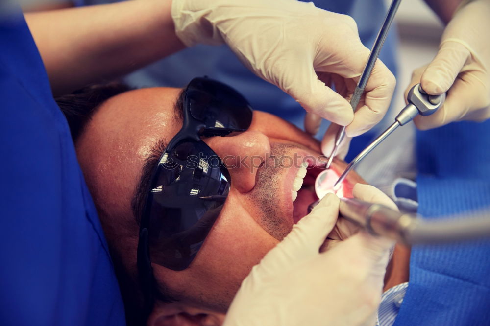 Similar – Seated young man is being examined his teeth by a dentist.