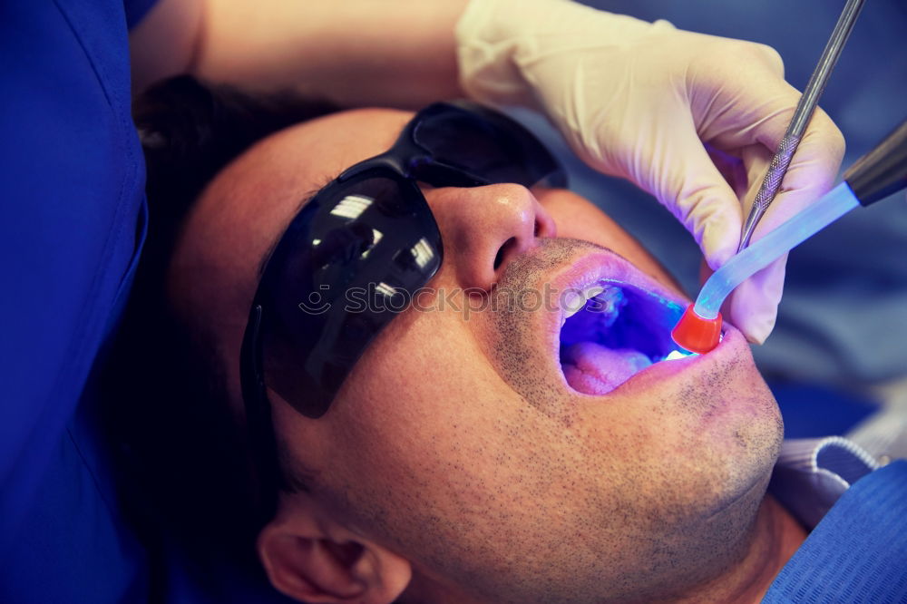 Similar – Seated young man is being examined his teeth by a dentist.