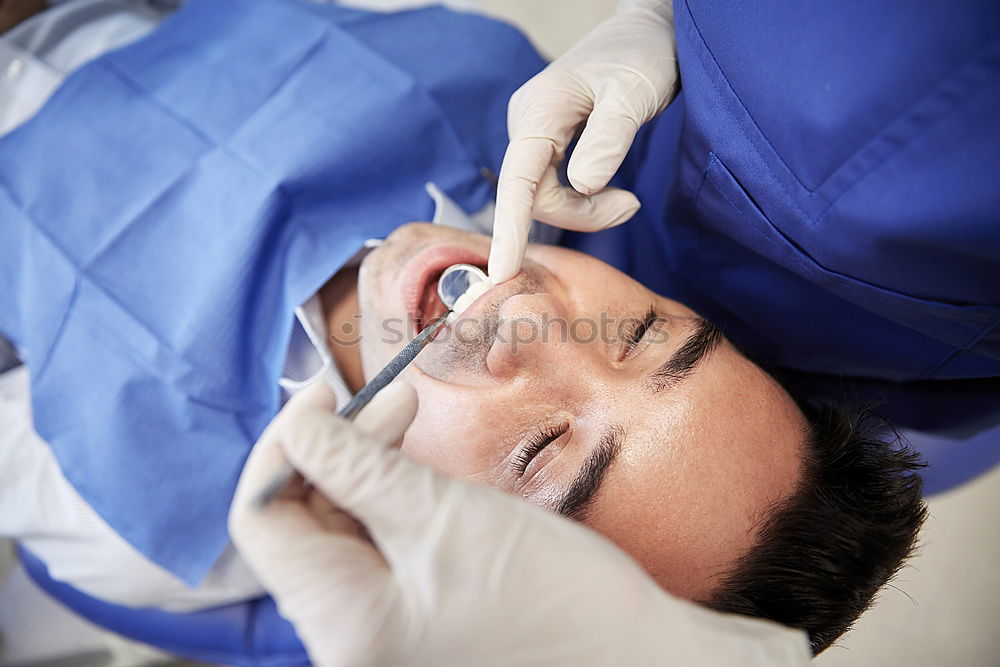 Similar – Seated young man is being examined his teeth by a dentist.