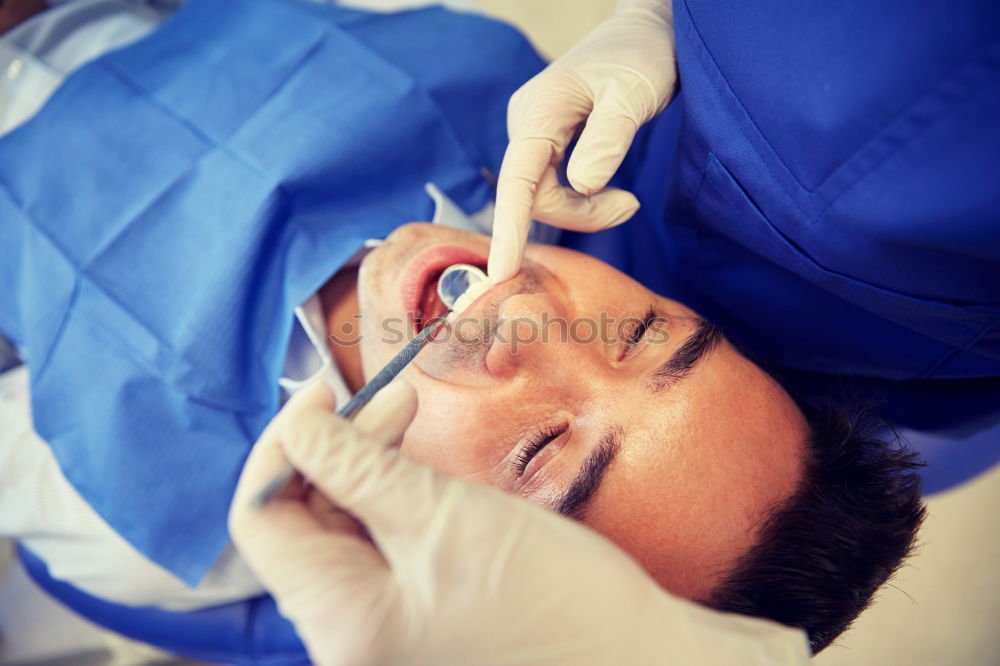 Similar – Seated young man is being examined his teeth by a dentist.