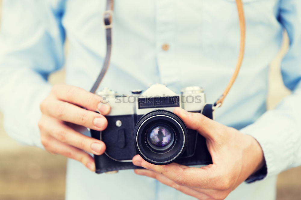 Similar – Close up of a photographer with her camera.