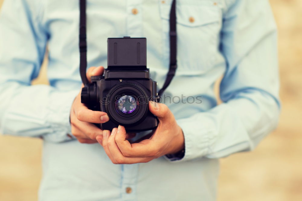 Similar – Close up of a photographer with her camera.