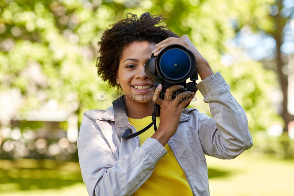 Similar – Close up of a photographer with her camera.