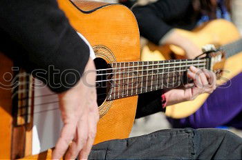 Similar – Image, Stock Photo Man playing guitar and composing music at home near a bright window on a sunny day. Casual musician sitting on the floor playing the guitar.