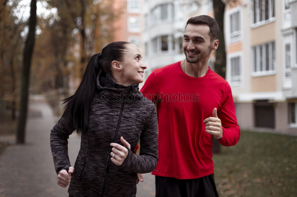 Similar – Couple in Fitness Attire Ready for Outdoor Workout