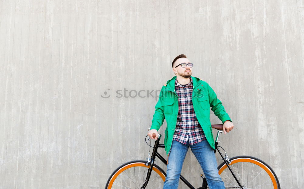 Similar – Young man riding bicycle and listening to music in headphones on city street