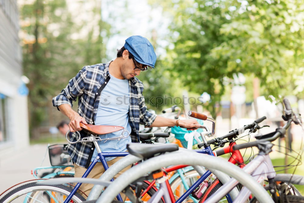 Similar – A young stylish man posing next to his bicycle.