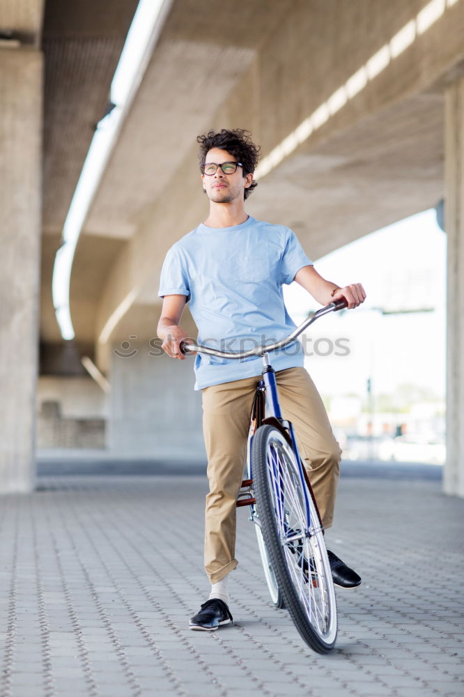 Similar – Handsome afro man walking with his bike.