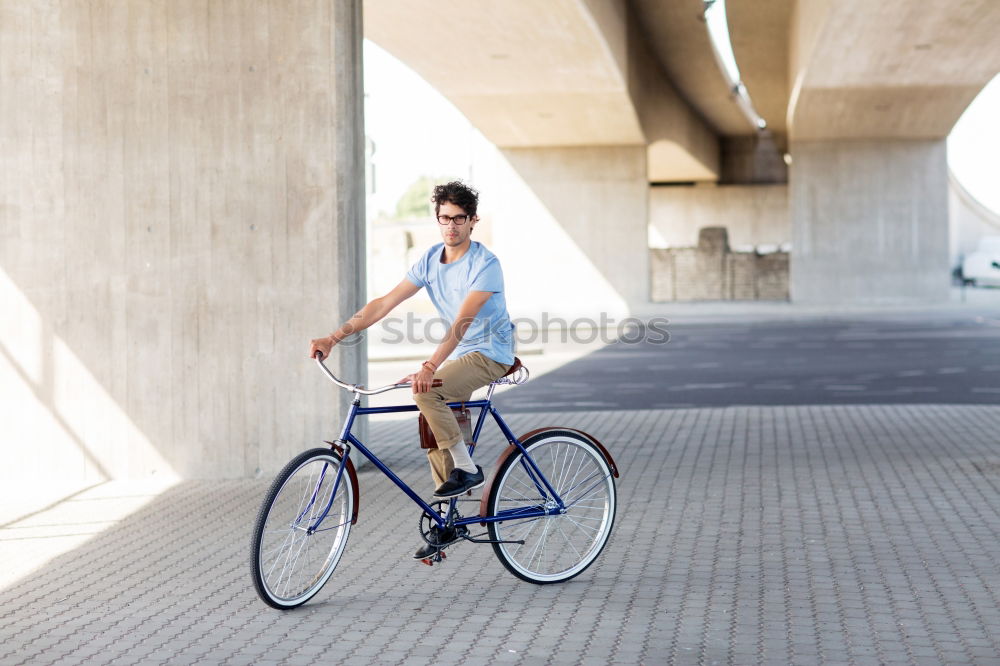 Similar – Mann mit Fahrrad auf Brücke stehend