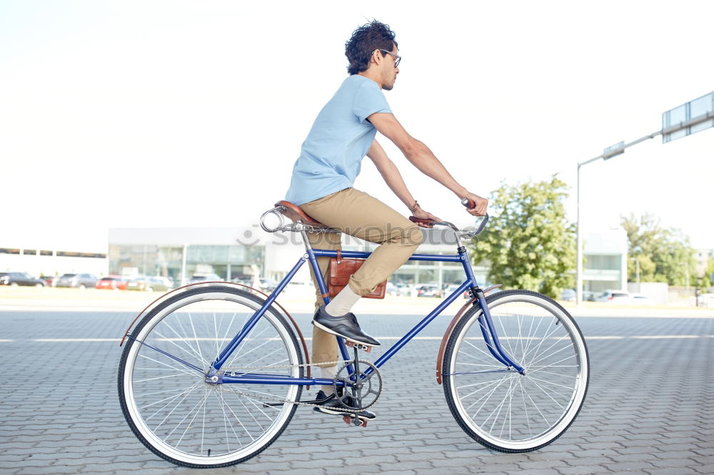 Similar – Image, Stock Photo Young man posing with bike on pavement