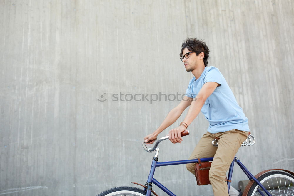 Similar – Image, Stock Photo Young man with mobile phone and fixed gear bicycle.