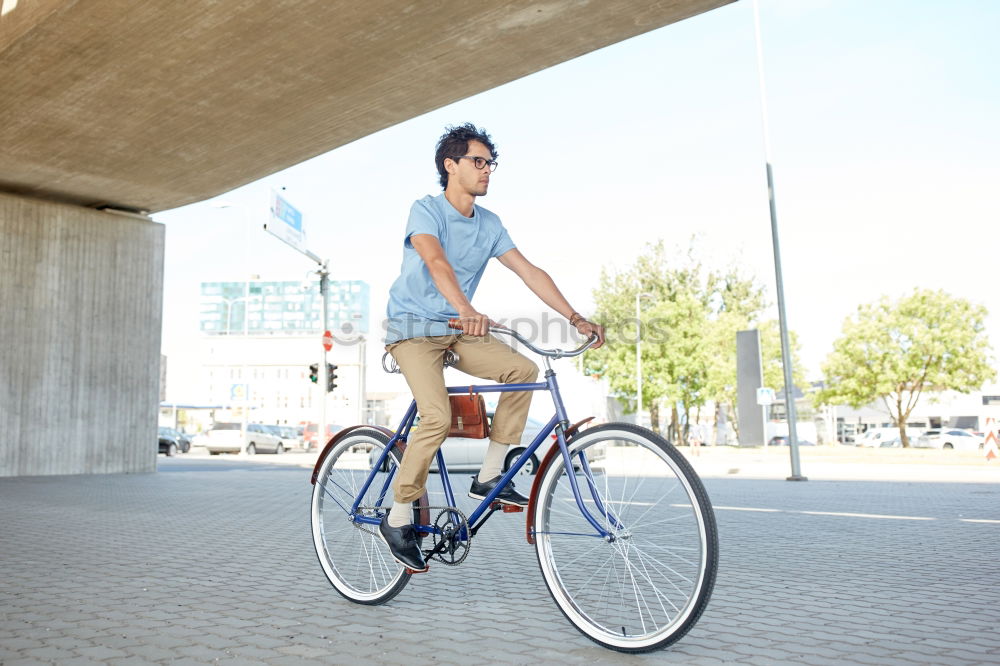 Similar – Image, Stock Photo Young man posing with bike on pavement