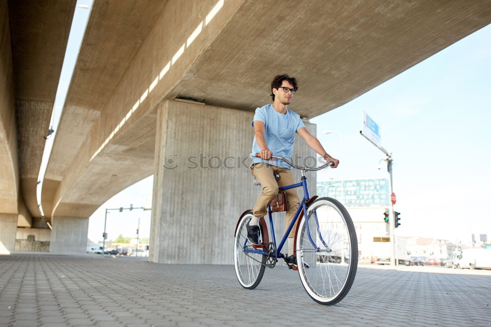 Similar – Image, Stock Photo Young man posing with bike on pavement