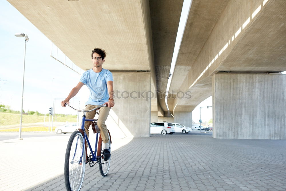 Similar – Image, Stock Photo Young man posing with bike on pavement