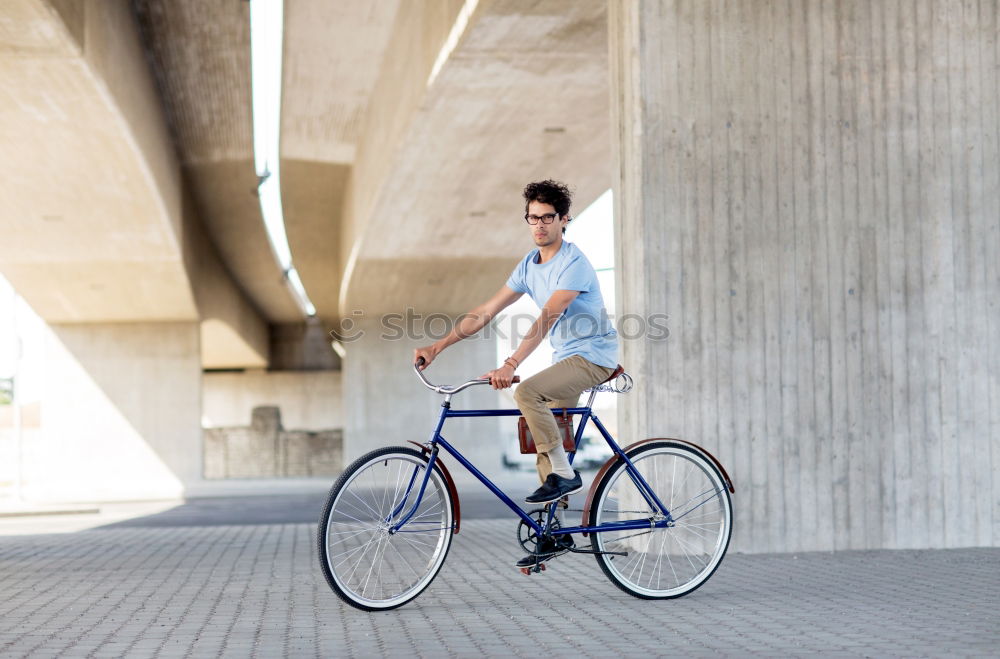 Similar – Image, Stock Photo Young man posing with bike on pavement