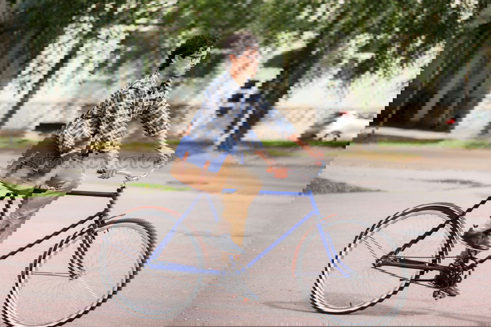 Similar – Image, Stock Photo Trendy adult man with retro high wheel bicycle on street against aged shabby building in township