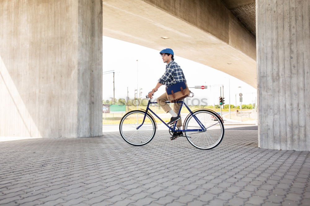 Similar – Mann mit Fahrrad auf Brücke stehend