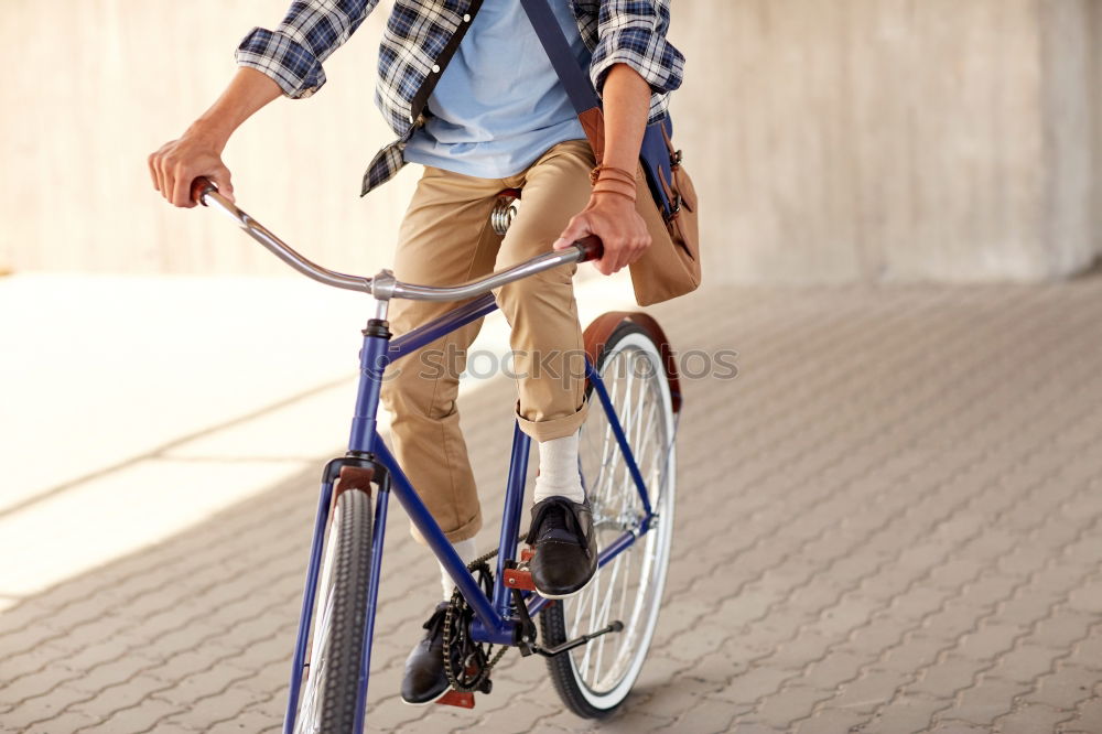 Similar – A young stylish man posing next to his bicycle.