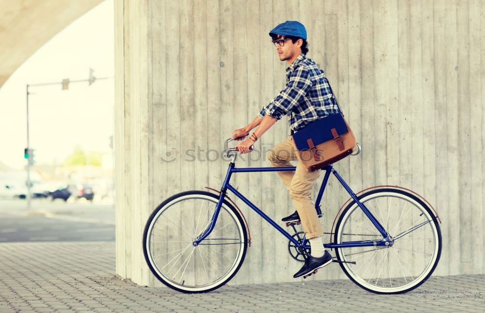 Similar – Stylish urban businessman standing on the street with bicycle