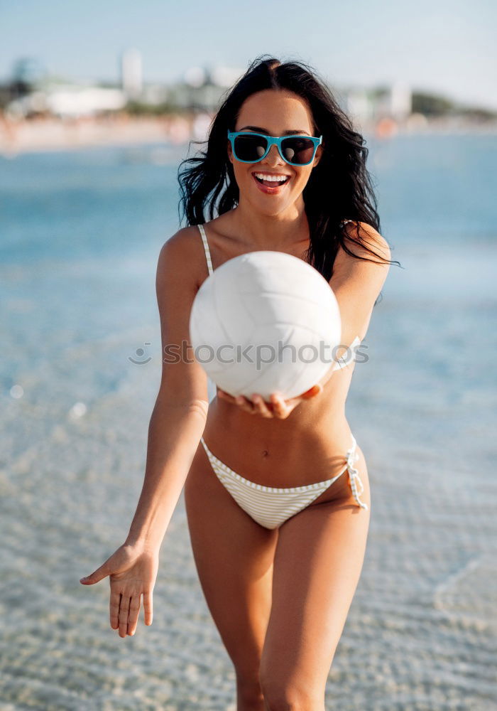 Similar – Young arabic woman with beautiful body in swimwear smiling on a tropical beach.