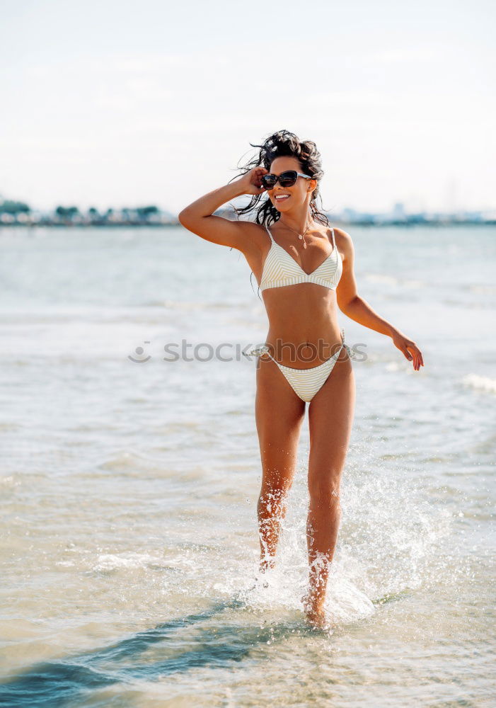 Similar – Image, Stock Photo Beautiful young woman posing on the sand in the beach
