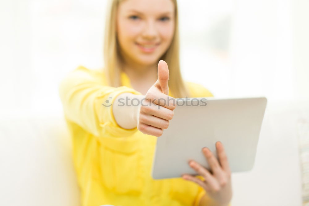 Young asian woman smiling and using tablet