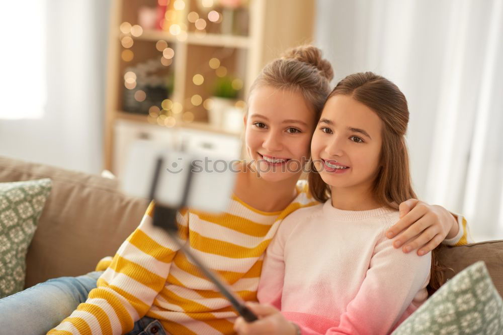 Similar – Image, Stock Photo Girl and boy reading a book sitting on the bed