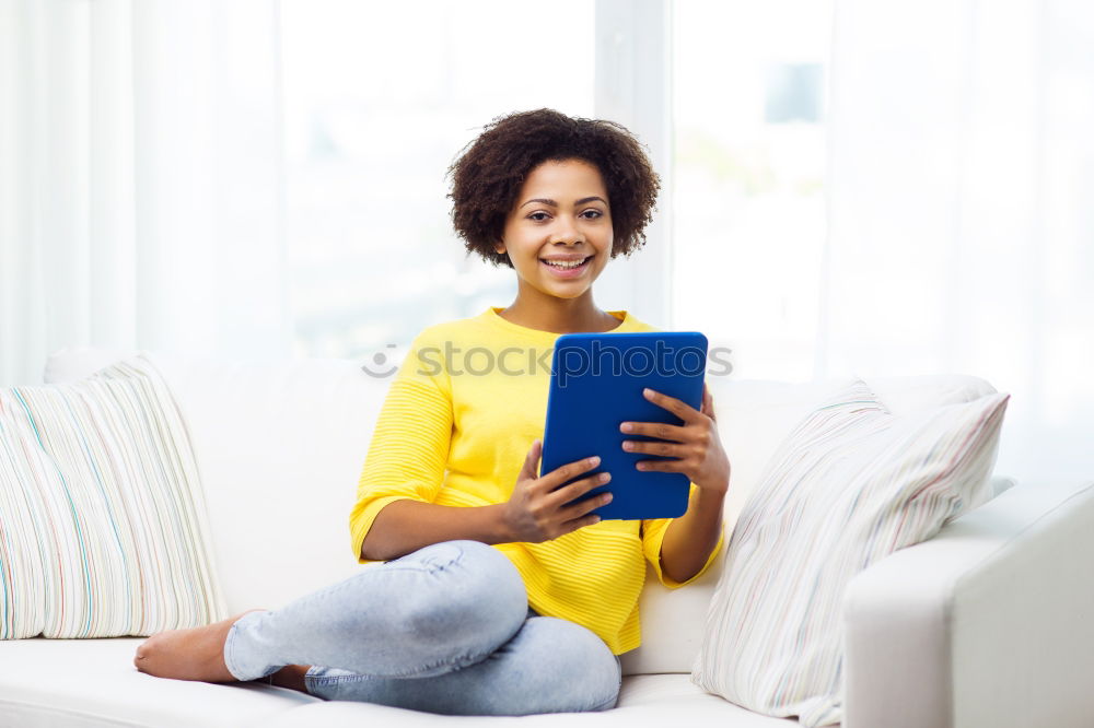 Similar – black woman reading on a sofa