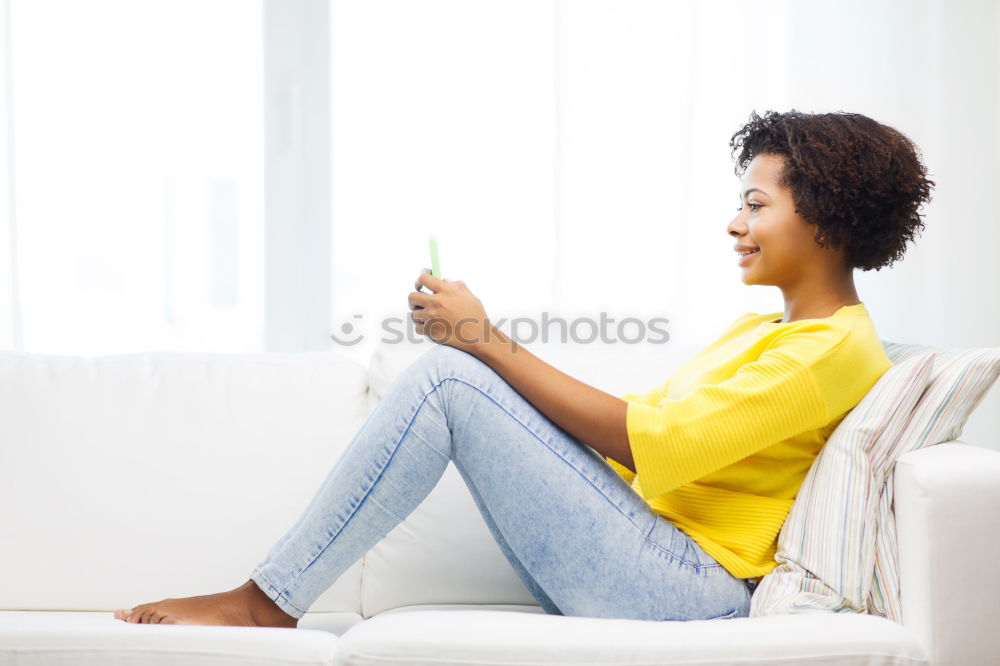 Similar – black woman reading on a sofa