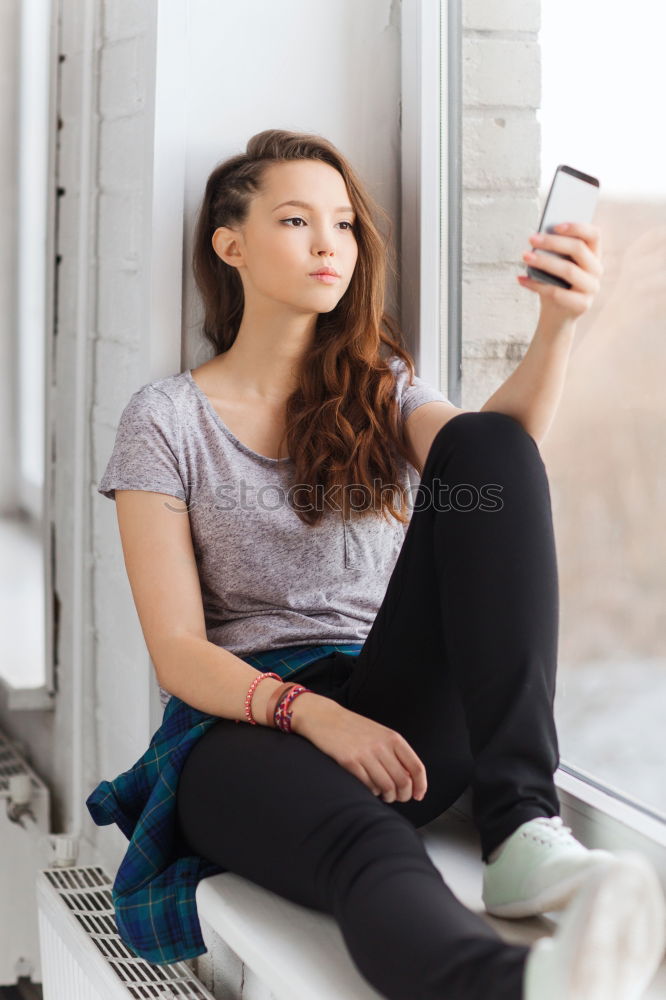 Similar – Dreaming girl looking away in window