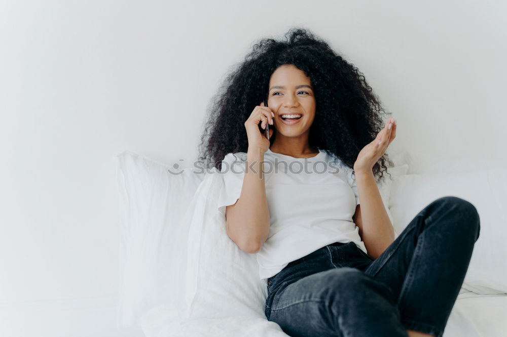 Similar – close up of a pretty black woman with curly hair smiling and lying on bed looking away