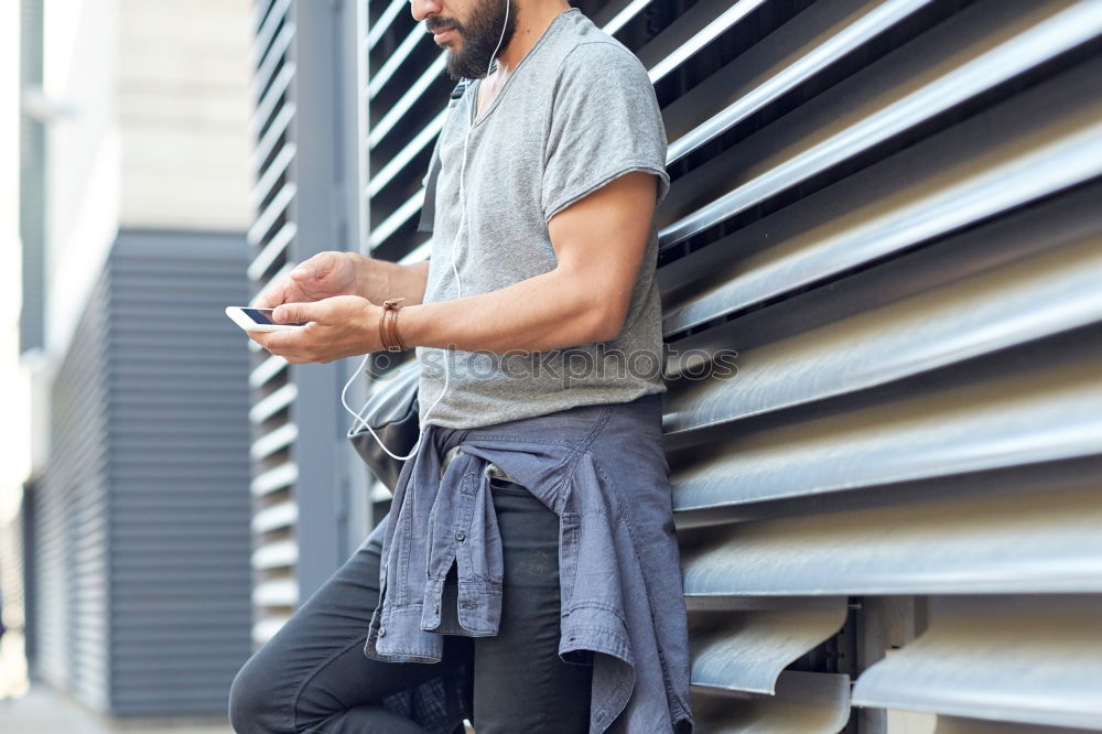 Similar – Image, Stock Photo Young smiling man looking at his smartphone in the street