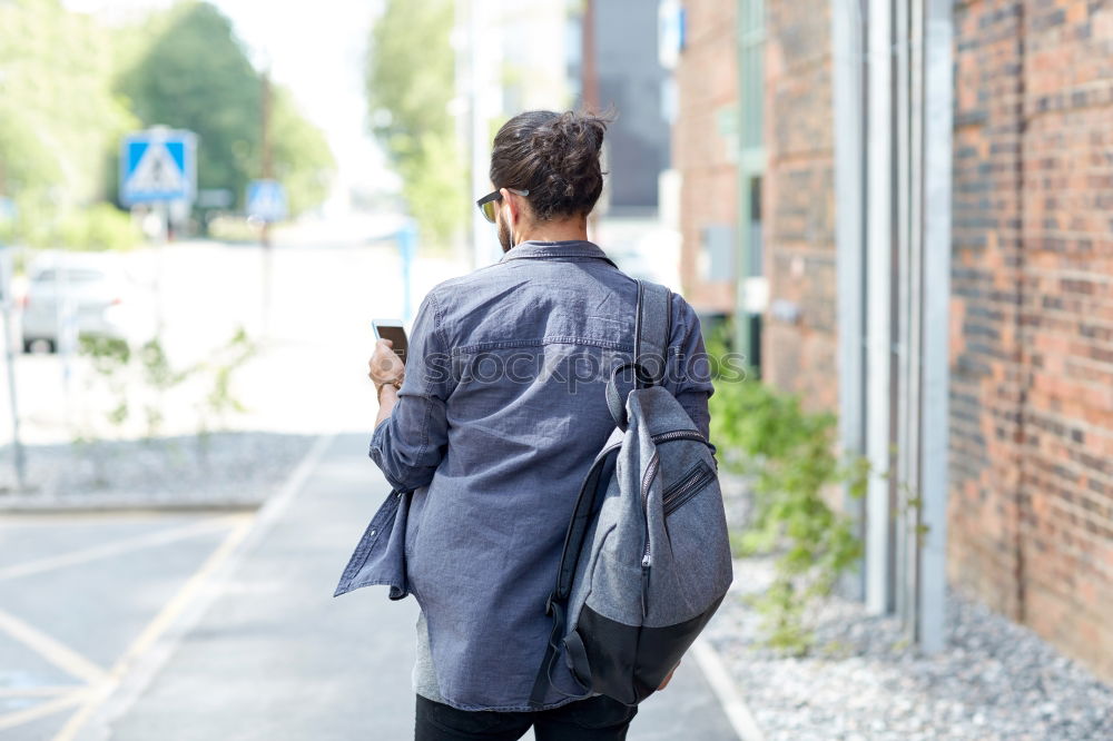 Similar – Young black man walking smiling down the street.