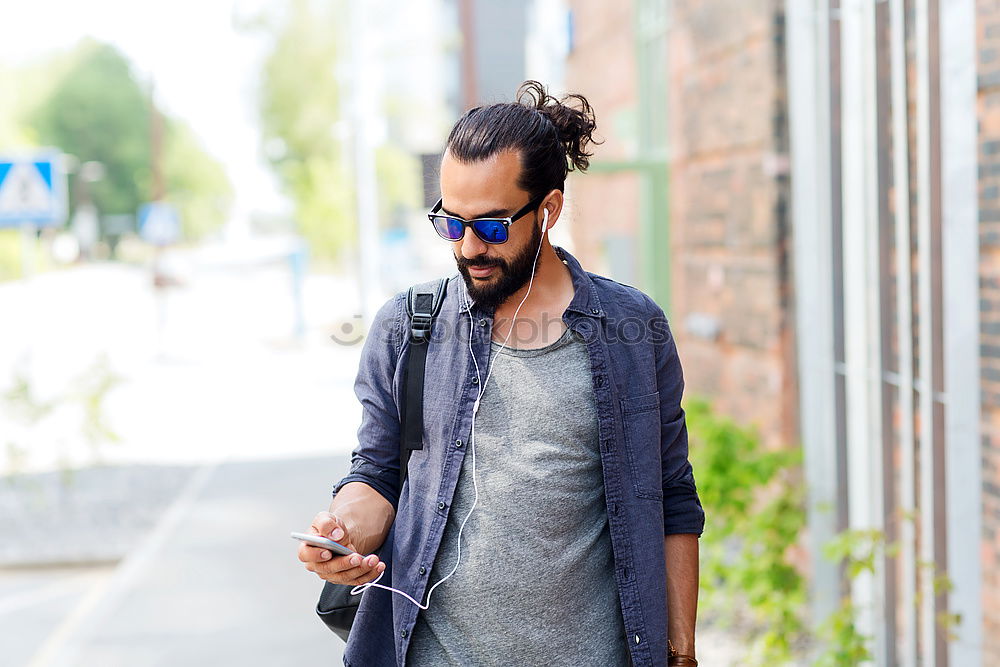 Similar – Image, Stock Photo Young smiling man looking at his smart phone outdoors