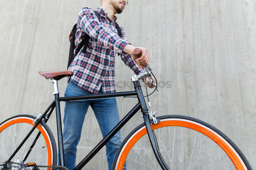 Similar – Young man is holding blue bike in urban street