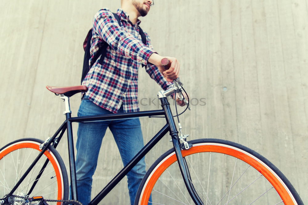 Similar – Young man riding bicycle and listening to music in headphones on city street