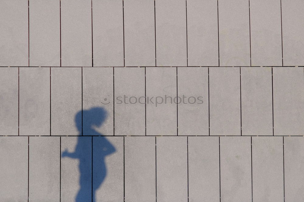 Image, Stock Photo elegantly dressed lady with black coat, red hat, red scarf and red pumps walks on a large square with concrete and patterned floor