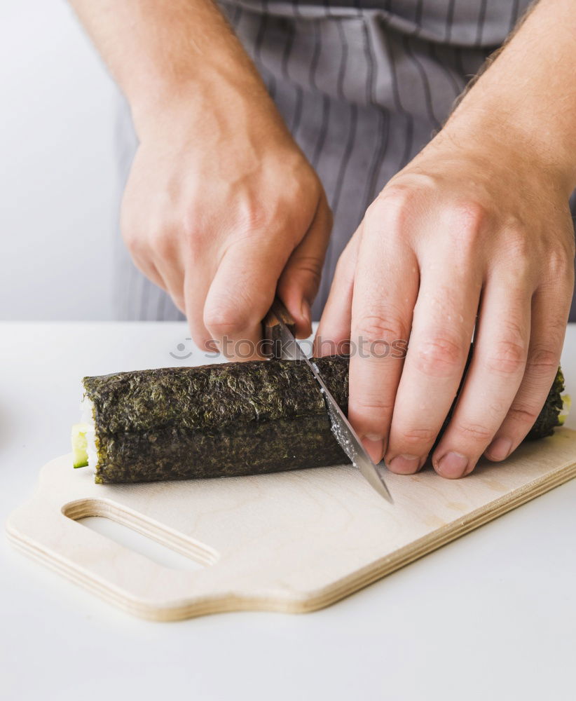 Similar – Woman chef hands rolling up japanese sushi