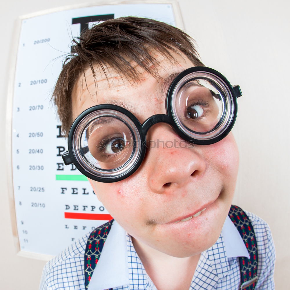 Similar – Image, Stock Photo surprised child looking through magnifying glass on brick background