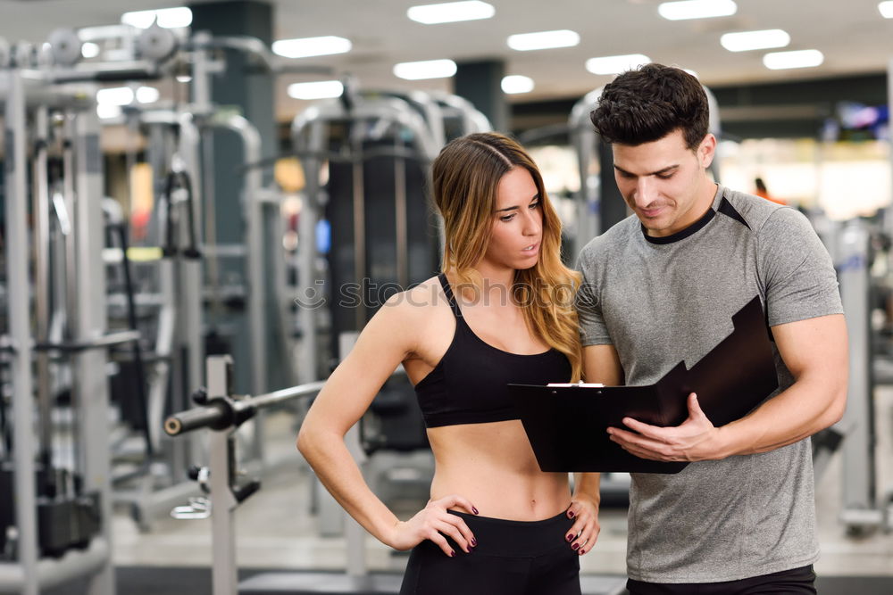 Similar – Female personal trainer helping a young man lift weights