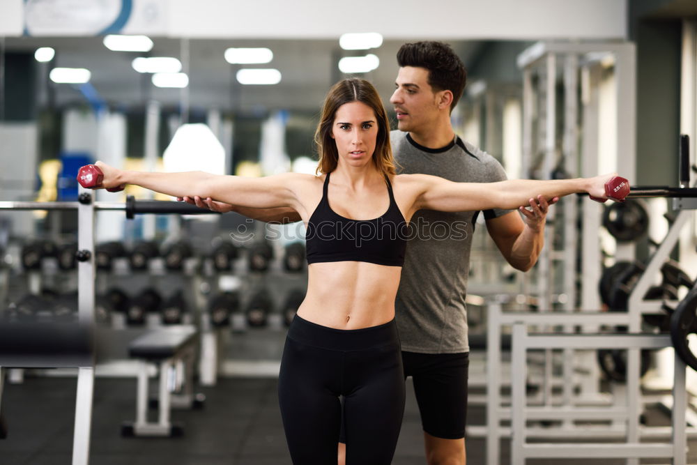 Similar – Image, Stock Photo Personal trainer helping a young woman lift dumbells