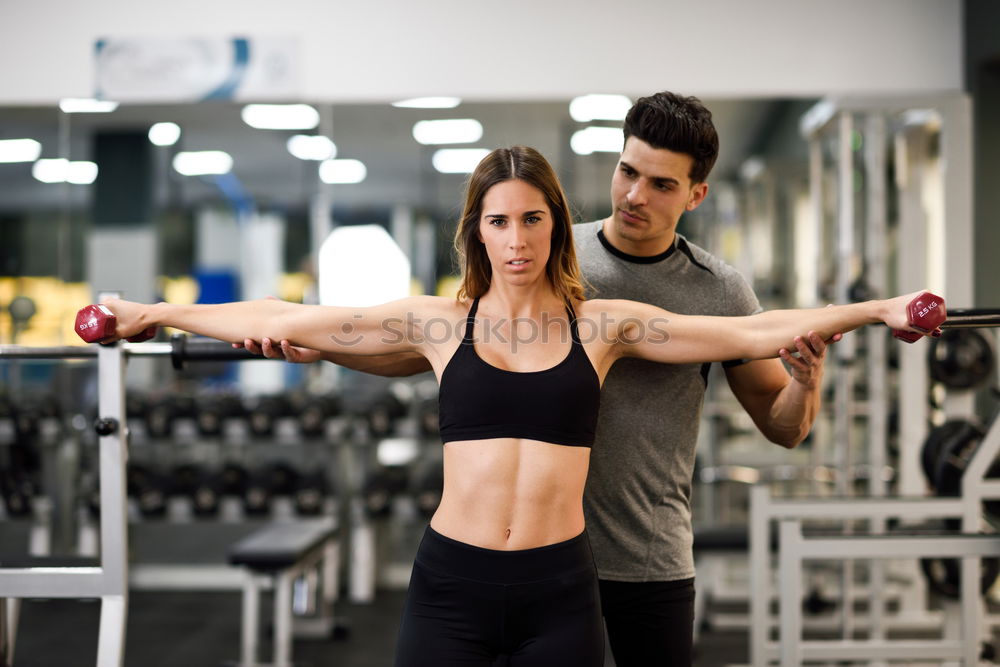 Image, Stock Photo Personal trainer helping a young woman lift dumbells