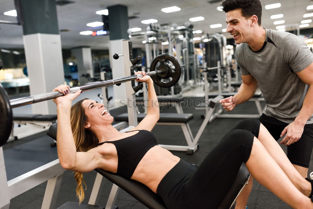 Similar – Personal trainer helping young woman lift weights