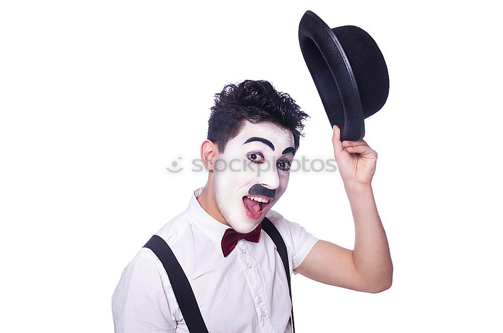 Similar – Young man with a clown costume is holding a little bike