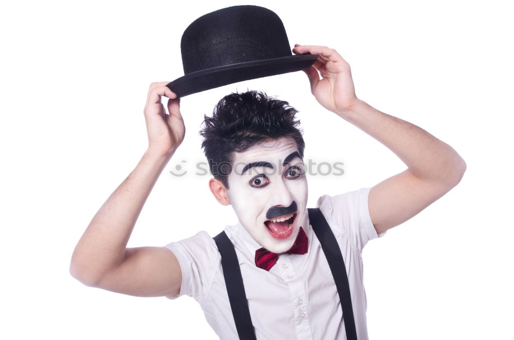 Similar – Young man with a clown costume is holding a little bike