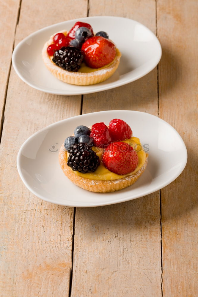 Similar – Delicious tartlets with raspberries and blueberries