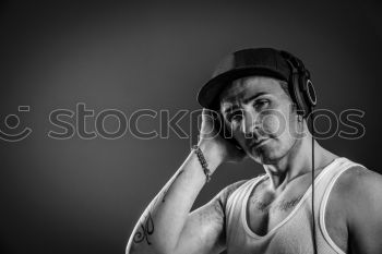 Similar – Man listens to music through Bluetooth headphones