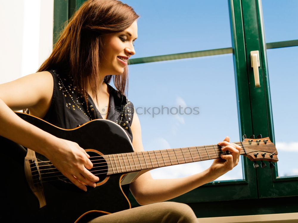 Similar – Mädchen spielt Ukulele im Gartenstuhl